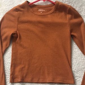 a orange long sleeve crop top